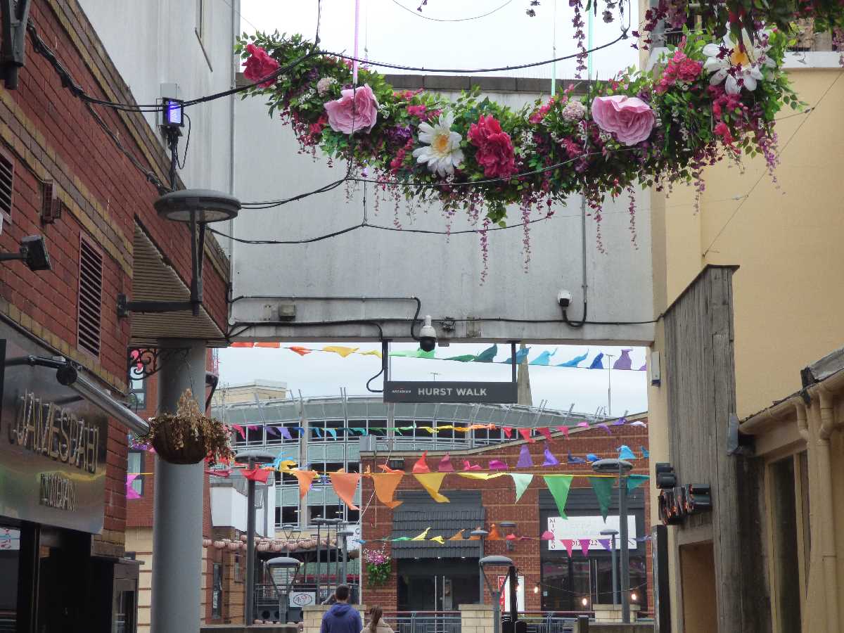 Floral canopy on Hurst Walk and rainbow bunting at The Arcadian